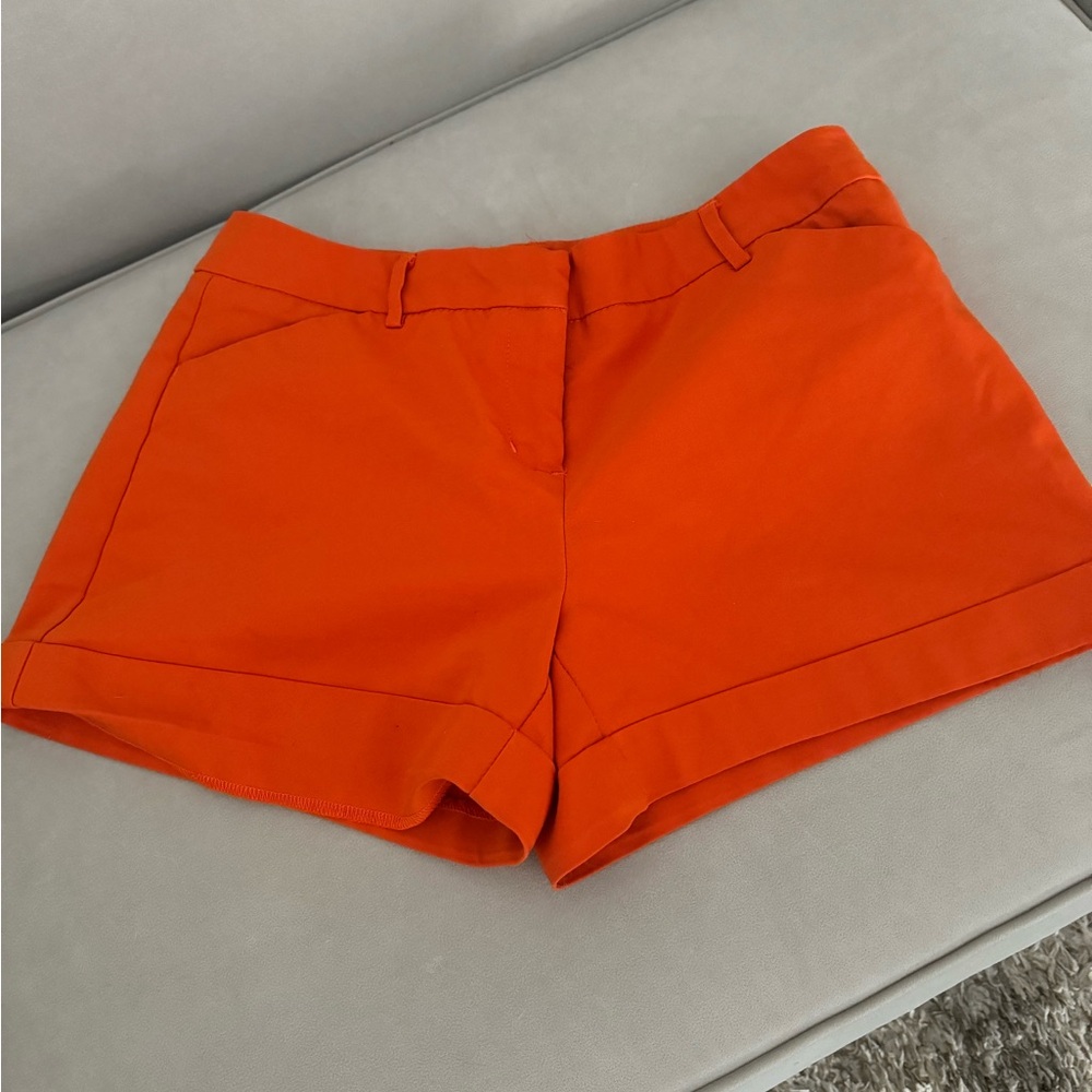 Versona orange shorts. Pockets and belt loops.